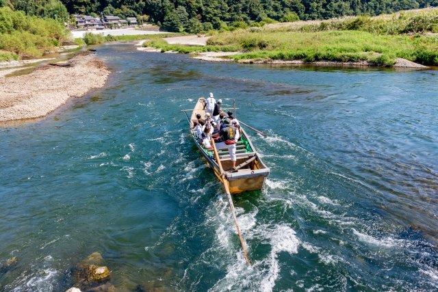 Boatmen navigating the Hozugawa River in Kyoto