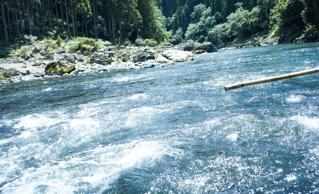 Boat passing through rapids on the Hozugawa River in Kyoto